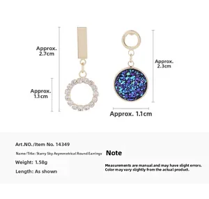 Detail view of starry blue asymmetric earrings with dimensions of 2.3cm and 2.7cm