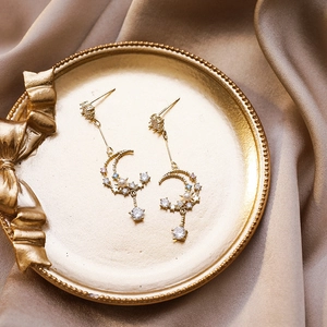 Gold moon and star tassel earrings with zircons and pearls on champagne silk