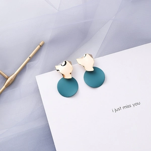Detailed close-up of blue-grey geometric earrings with gold irregular metal and matte circles