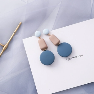 Detailed view of three-tier long geometric earrings with blue fabric and matte resin