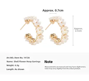 Detail view of gold C-shaped hoop earrings with shell flower texture and size dimensions