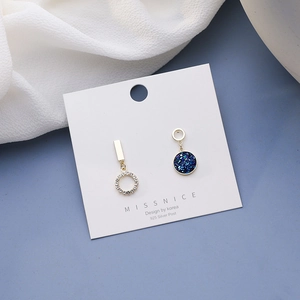 Detail of asymmetric blue starry earrings with 925 silver posts on a display card