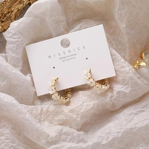 Elegant gold C-shaped hoop earrings with white shell flower petals and 925 silver posts