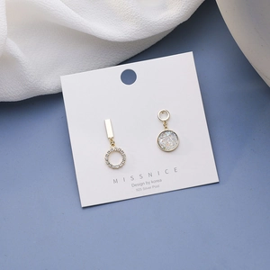 Detailed shot of asymmetric earrings with blue crystal clusters on a 925 silver post