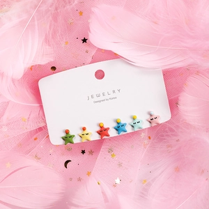 Detail of 6-pair colorful star earrings set with cute faces on display card