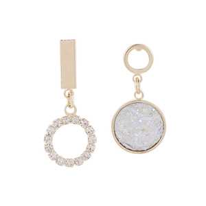 Detail of asymmetric gold earrings featuring crystal clusters and sparkling rhinestones