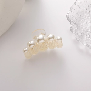 Detail einer eleganten Perlen-Haarklammer mit cremigem Glanz auf klarem Acryl-Clip