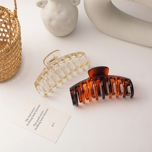 Elegant amber and champagne hair claws for buns, featuring glossy acrylic in French style