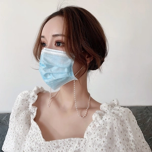 Elegant white pearl strap for glasses and masks shown on a blue disposable mask