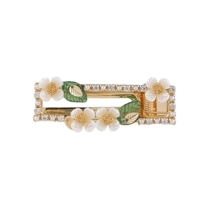 Rectangle gold hair clip featuring white shell flowers, green leaves, and pearls