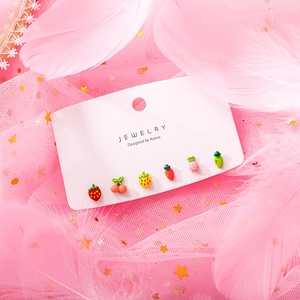 Detailed view of six-piece sweet fruit stud earrings set on a white display card