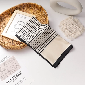 French vintage satin skinny scarf with geometric lines on a decorative woven basket