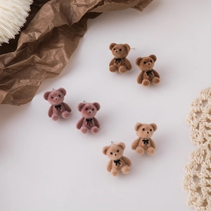 Cute flocked bear stud earrings with bow tie detail in brown, pink, and tan colors