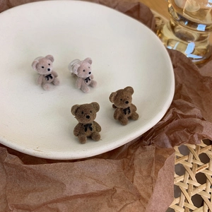 Cute flocked bear stud earrings with bow tie detail in brown and pink colors