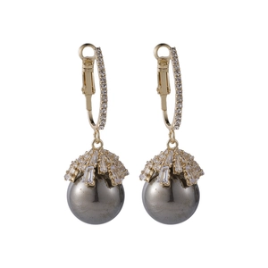 Detail view of gold drop earrings with grey pearl and cubic zirconia crystal settings