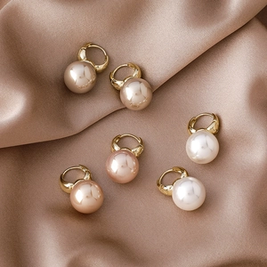 Detailed display of elegant pearl hoop earrings in champagne, purple, and white tones