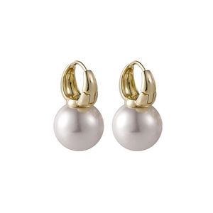 Detailed shot of elegant gold-tone U-shape hoop earrings with large round pearls