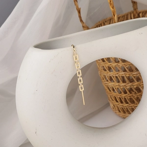Detail of gold chain link ear cuff featuring micro-paved sparkling cubic zirconia crystals