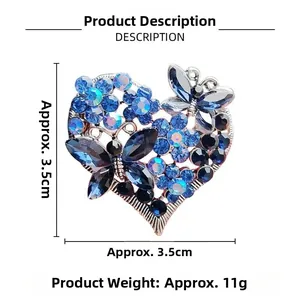 Detail view of rhinestone heart brooch with blue crystals and butterfly motif