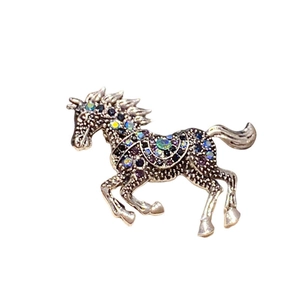 Close-up of luxury horse brooch with multicolor crystals and silver-tone finish