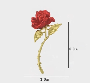 Detailed view of red rose brooch with golden leaves, measuring 6.0cm high and 3.0cm wide