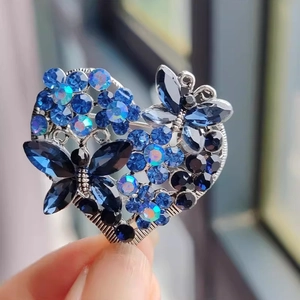 Luxurious butterfly heart brooch featuring blue rhinestones and floral crystal accents
