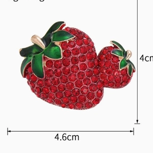Sparkling double strawberry brooch with red rhinestones and green leaves on gold base