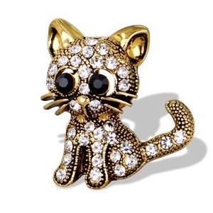 Vintage cat brooch in antique gold finish with sparkling crystals on white background