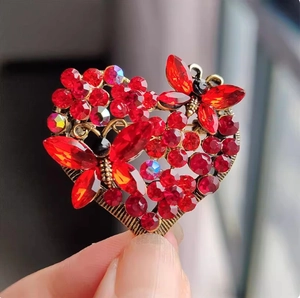 Vintage heart brooch with red crystals and butterfly accents in a high-quality metal finish