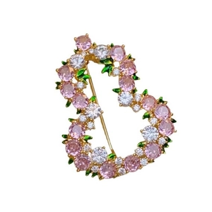 Elegant gold heart brooch with pink and white cubic zirconia and green enamel leaves