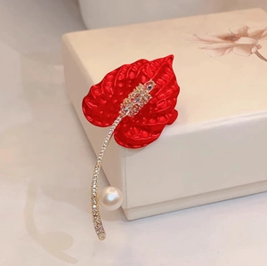 Luxurious calla lily brooch with red enamel petals, sparkling crystals and a white pearl