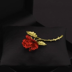 Exquisite French red rose brooch with golden stem on black leather jewelry pillow