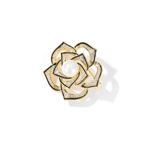 Detail of vintage camellia brooch with gold petals, micro crystals, and a white pearl