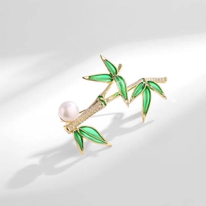 Bamboo brooch with green enamel leaves, white pearl, and crystal inlay in gold finish