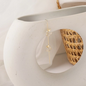 Detailed close-up of a gold butterfly ear crawler with sparkling zircon crystal stones