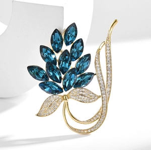 Elegant blue crystal brooch with marquise stones and white rhinestones in gold setting