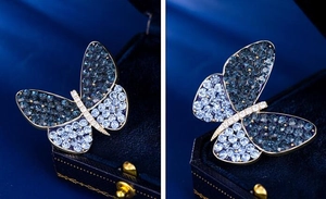 Macro shot of blue gradient butterfly brooch with crystals and premium velvet jewelry box