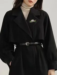 Exquisite panda brooch with black and white rhinestones and green bamboo leaves on a black coat