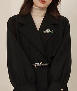 Exquisite panda brooch with sparkling crystals and green bamboo leaves on black coat