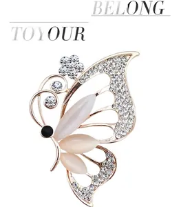 Detailed macro view of butterfly brooch with opal cat eye wings and small white crystals