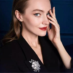 Elegant silver pearl brooch with rhinestones on black blazer lapel for women
