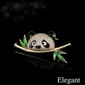 Elegant gold panda brooch with sparkling white rhinestones and green bamboo leaves