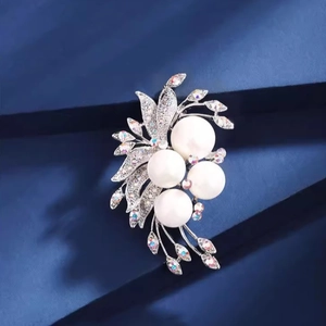 Elegant silver phoenix tail flower brooch with white pearls and sparkling rhinestones