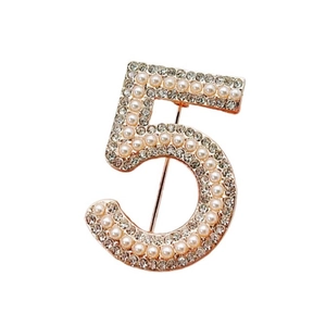 Elegant gold brooch in number 5 shape with white pearls and sparkling rhinestones