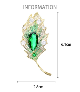 Detailed dimensions of the leaf-shaped brooch with green gemstones and zircon accents