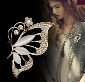 Macro detail of butterfly brooch featuring opal stone and crystal rhinestones