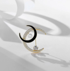 Elegant double crescent moon brooch with black enamel and sparkling white zircon pavé