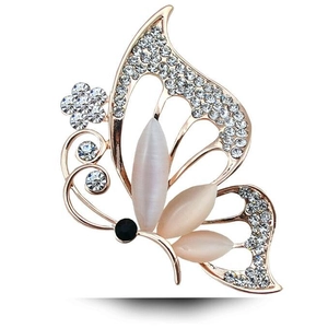 Elegant rose gold butterfly brooch with cat's eye stone and sparkling crystals on white base