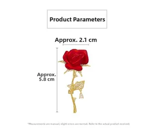 Detail of red rose brooch with golden stem, sparkling rhinestones and drop pendant