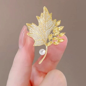 Elegant maple leaf brooch with yellow crystal, cubic zirconia, and white pearl decoration